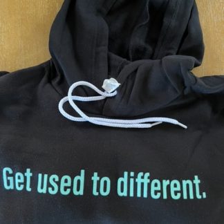 black hoodie with "Get used to different" printed on the front