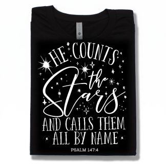 He Counts the Stars and call them all by name on the front of a black t-shirt